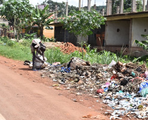 Man picking through rubbish in Kampala