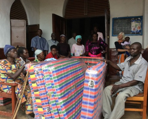 Giving the mattresses to the people