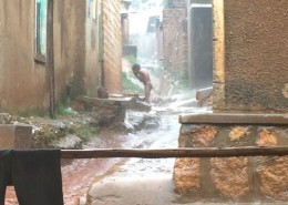 A child showering in the rain in Kampala