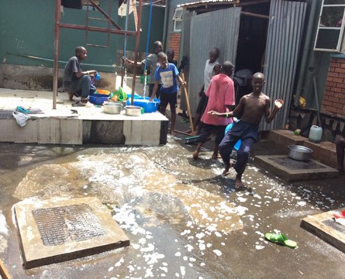 Children cleaning their compound
