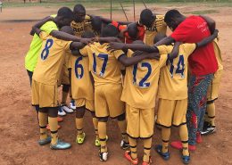 Street children pray before they play foot balls