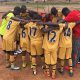 Street children pray before they play foot balls