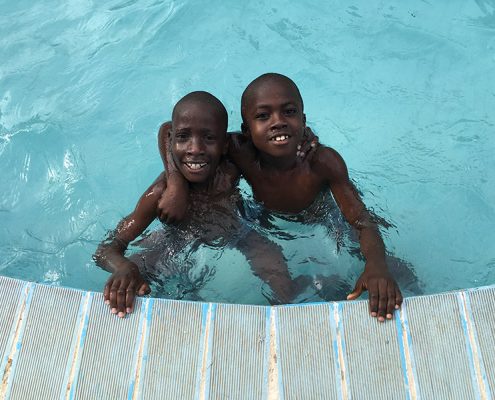 Two of the street children in the swimming pool