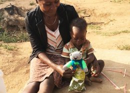 Young girl receiving a teddy bear