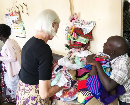 Jane and one of the street children sorting out donated clothes