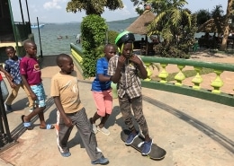 Street children playing with a skateboard