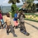 Street children playing with a skateboard