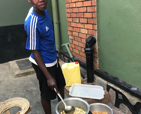 A street child cooking