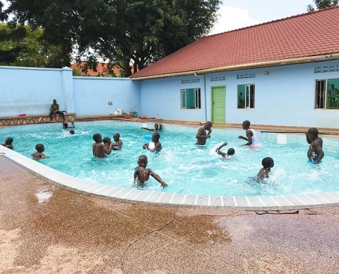 Street boys playing in the swimming pool