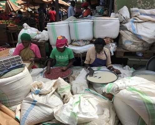 Women cleaning beans at the market