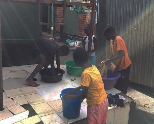 Street children washing clothes