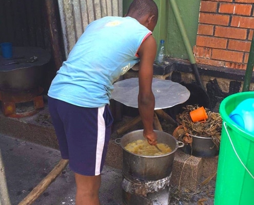 A street child cooking