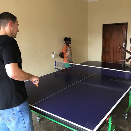 Flo playing table tennis with the boys