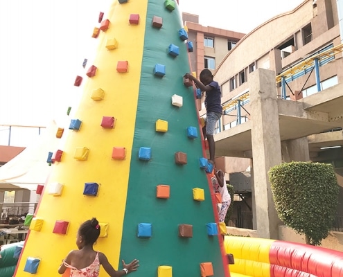 Street boy playing on a climbing wall