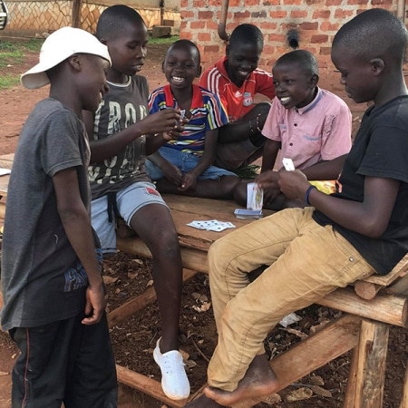 Group of street children playing cards