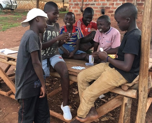 Group of street children playing cards