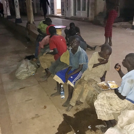 Some street boys enjoying a takeaway