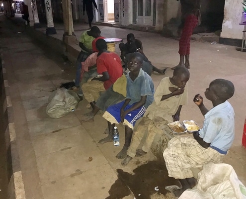 Some street boys enjoying a takeaway