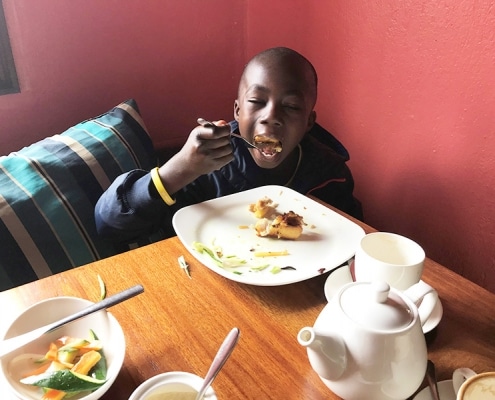 One of our street boys eating