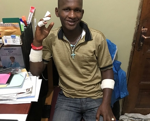 One of our street boys with injured fingers