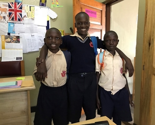 Three former street boys return home from school