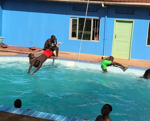 Street children playing in the swimming pool