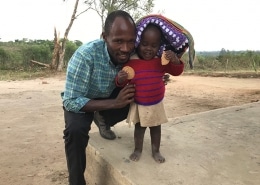 Ugandan girl with a donated jumper and blanket