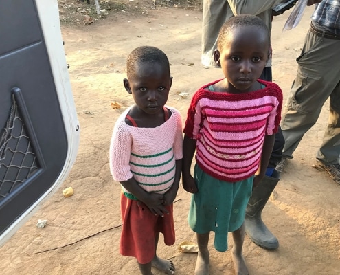 Two Ugandan girls in donated jumpers