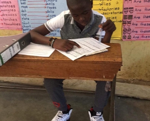 Street boy taking test for school