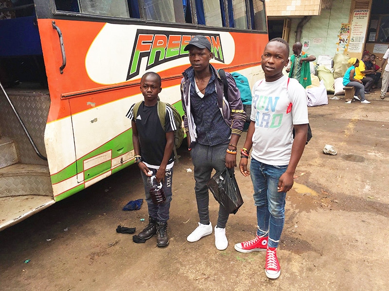 Three of our street children getting on a bus
