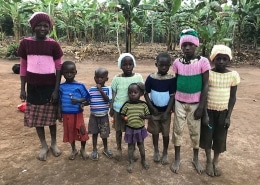 Ugandan children wearing donated jumpers