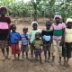 Ugandan children wearing donated jumpers