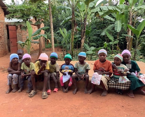 Ugandan children with donated hats and toys