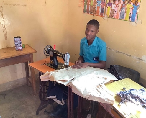 A former street child learning to sew
