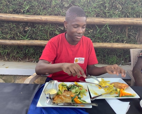 A former street child eating lunch