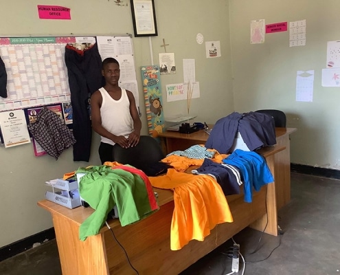 One of the street boys making clothes