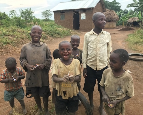 Ugandan children happy with sticky lollipops