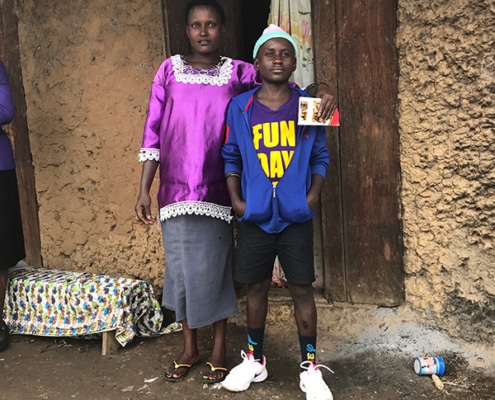 Ugandan street child with his mother