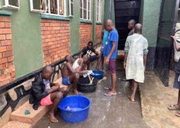 Street boys cleaning their shoes