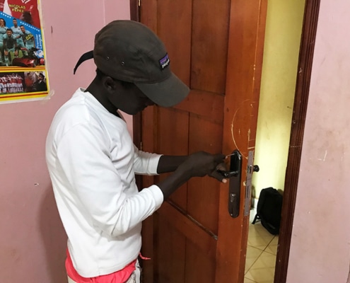 One of our boys fixing a door lock