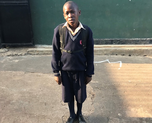 A former street boy back from school