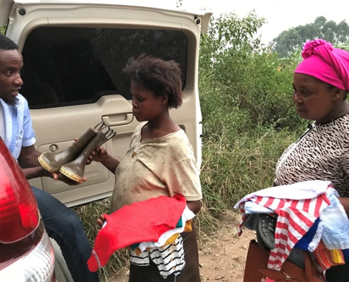 Giving donated clothes to the villagers
