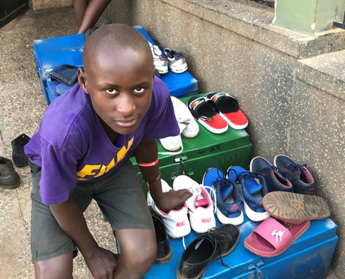 Another street child with donated shoes