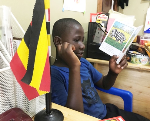 One of our street boys reading