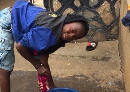 Street boy washing his clothes