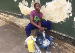 A street boy washing his clothes