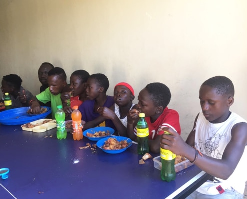 Ugandan children eating chicken