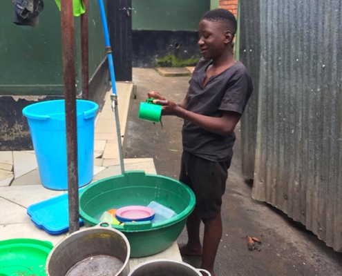 One of our street children washing up