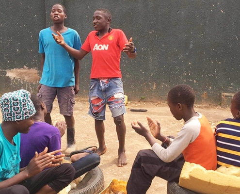 Two former street boys entertaining