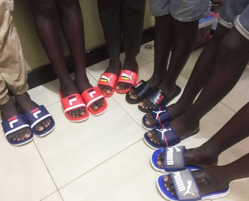 Street boys in donated sandals